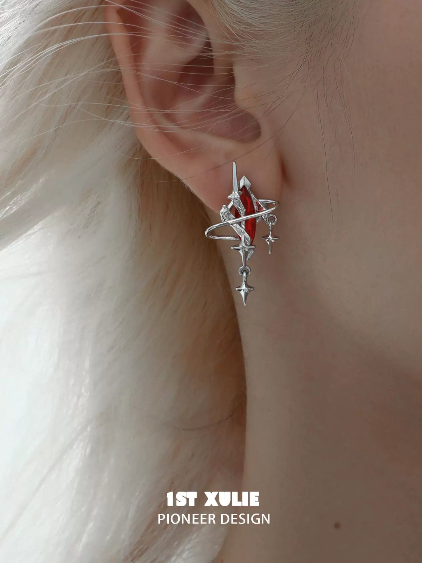 Y2K mystic earrings featuring a unique design with silver accents and a red gemstone