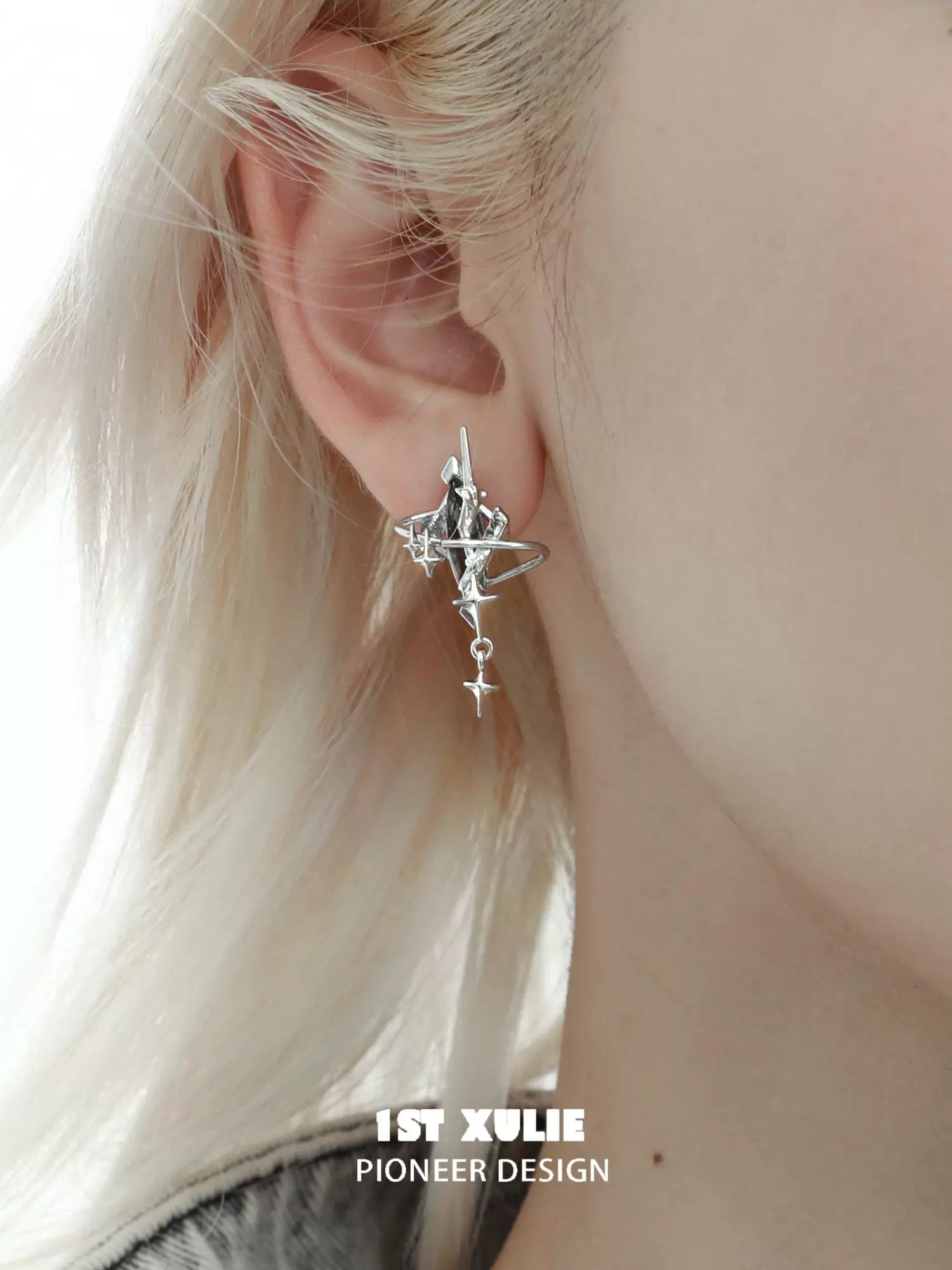 Y2K mystic earrings in silver featuring a unique swirl design and celestial charm