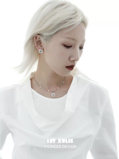 Y2K pearl earrings styled elegantly with a white blouse for a modern sophisticated look