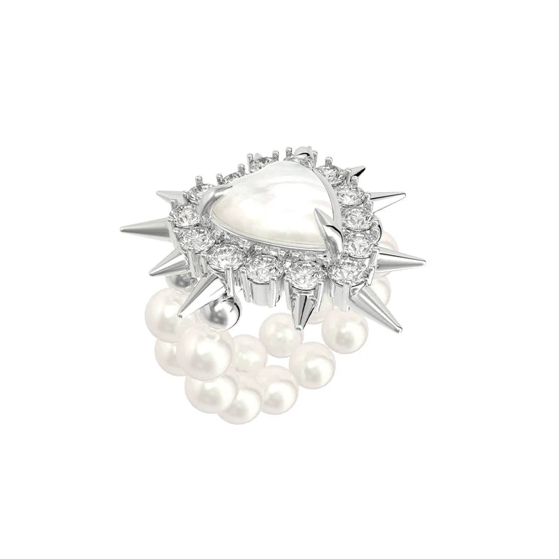 SUN HUNTER Y2K pearl rivet ring featuring a heart-shaped stone and spiked accents