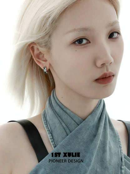 Model wearing Y2K planetary earrings showcasing a modern chic look with a soft expression
