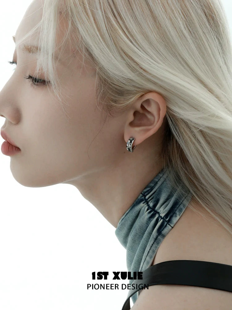 Stylish Y2K planetary earrings showcased on a model with a sleek hairstyle