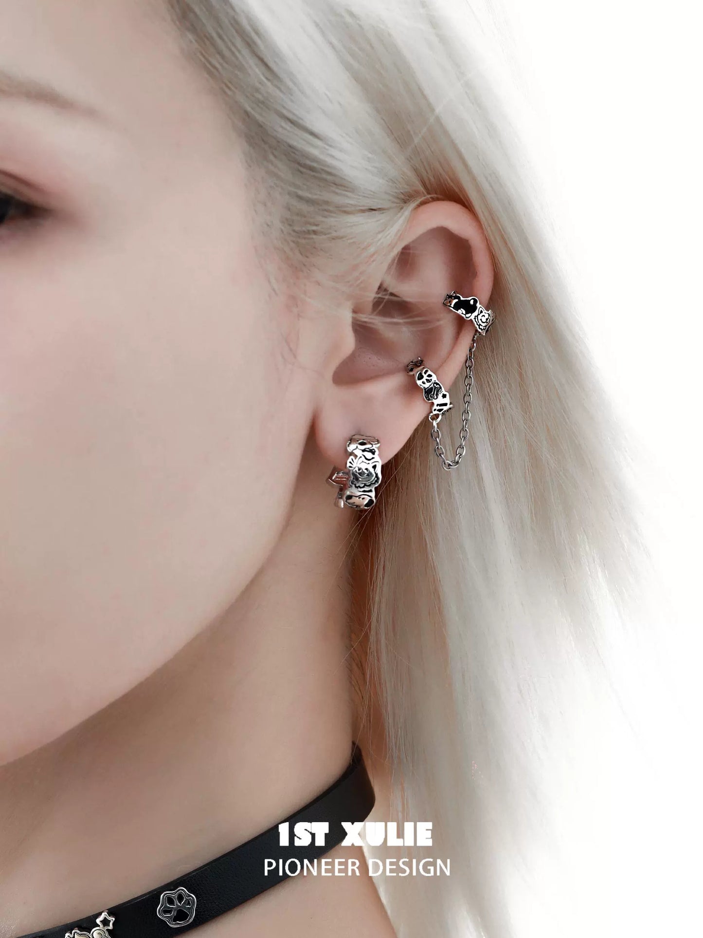 Y2K puppy chain earrings showcasing a unique design on a model's ear with silver detailing