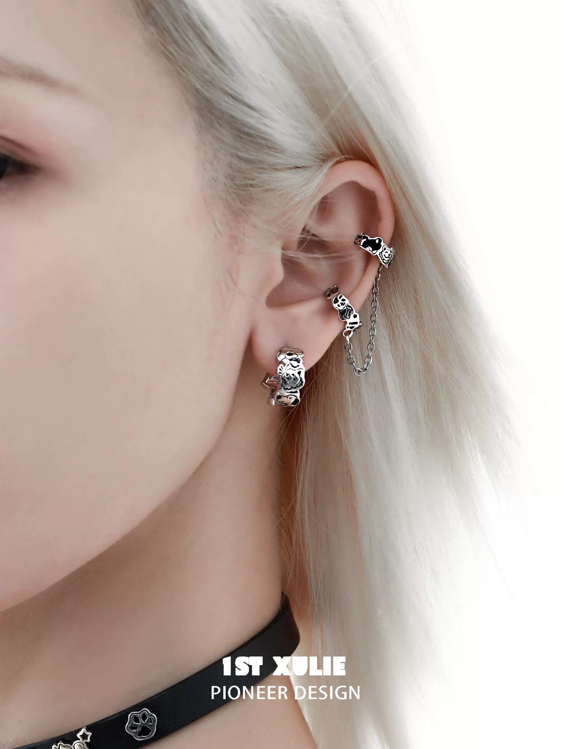 Y2K puppy chain earrings showcasing a unique design on a model's ear with silver detailing
