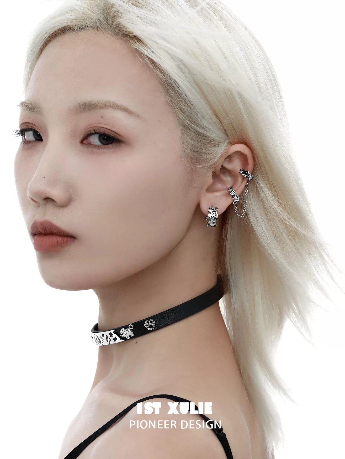 Trendy model wearing Y2K puppy chain earrings and a stylish black choker necklace