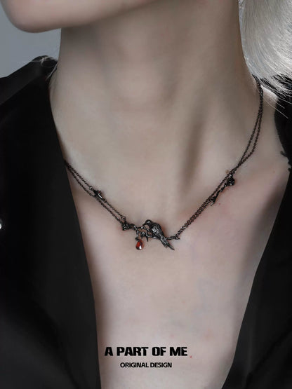 Y2K raven rose necklace from A PART OF ME featuring intricate charms and dark metal chains