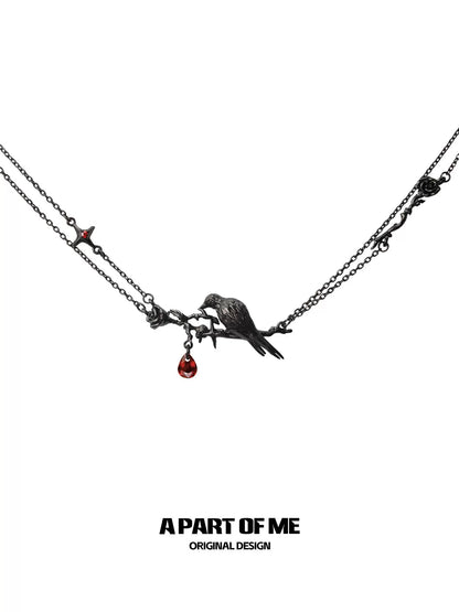 Y2K raven rose necklace featuring a bird perched on a branch with a red gemstone drop