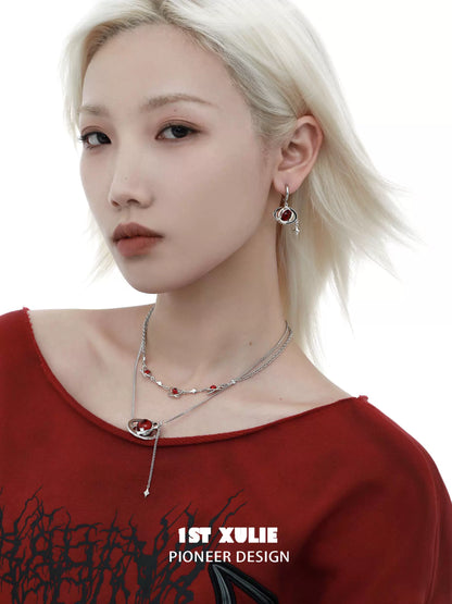 Y2K red planet earrings featured with stylish design worn by a model with blonde hair