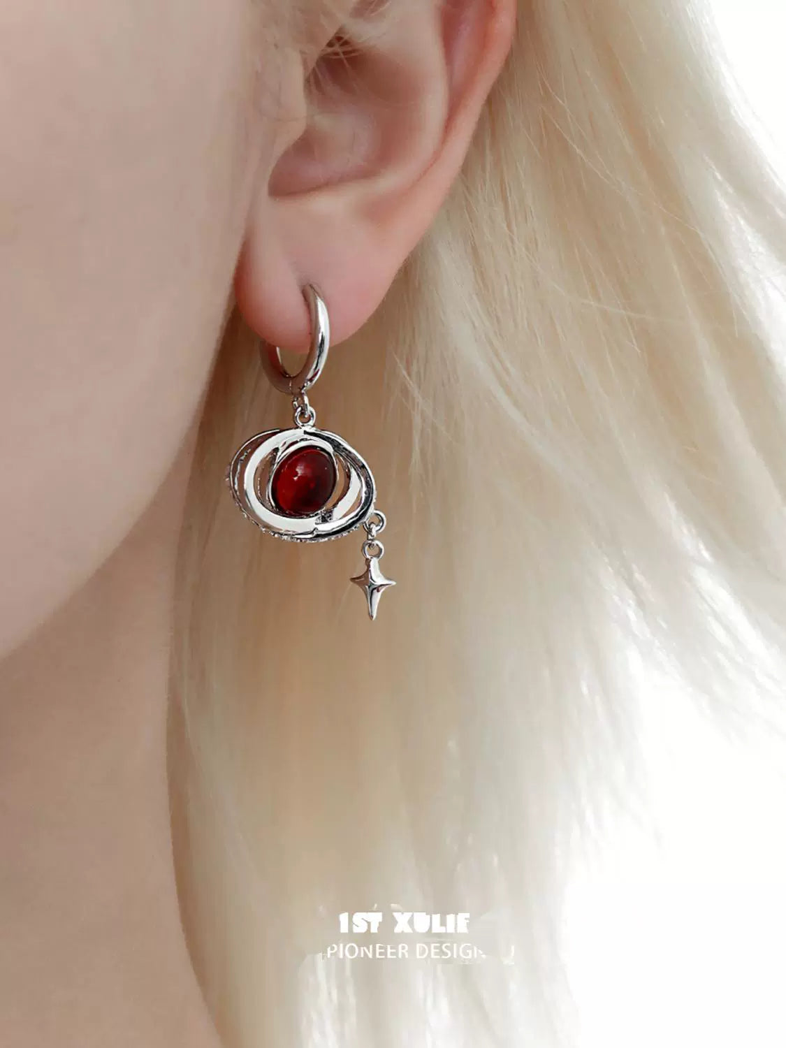Y2K red planet earrings with a silver spiral design and a dangling star charm