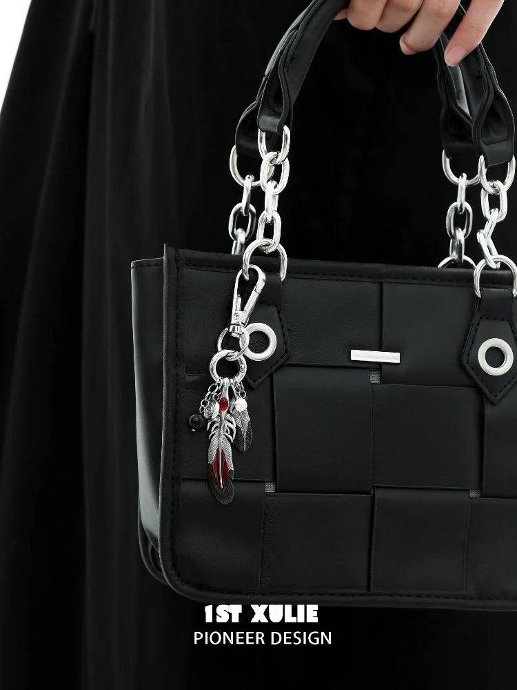 Stylish black handbag with silver chain and Y2K red witch feather necklace charm attached