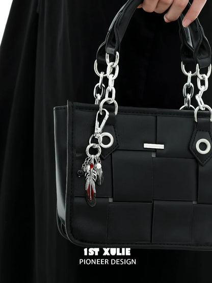 Stylish black handbag with silver chain and Y2K red witch feather necklace charm attached