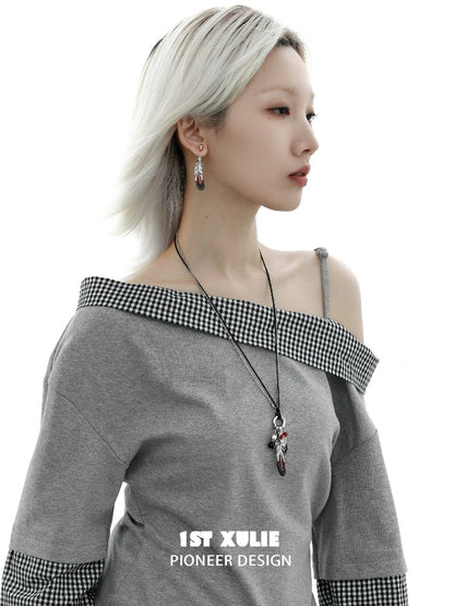 Model wearing Y2K red witch feather necklace paired with off-shoulder gray top for a stylish look