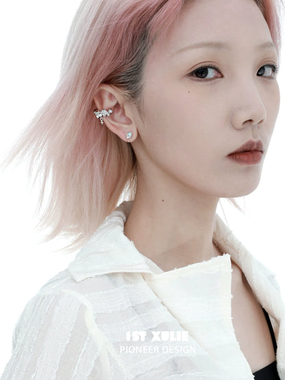Model wearing Y2K thorned crown earrings with unique design and sparkling accents in a styled look