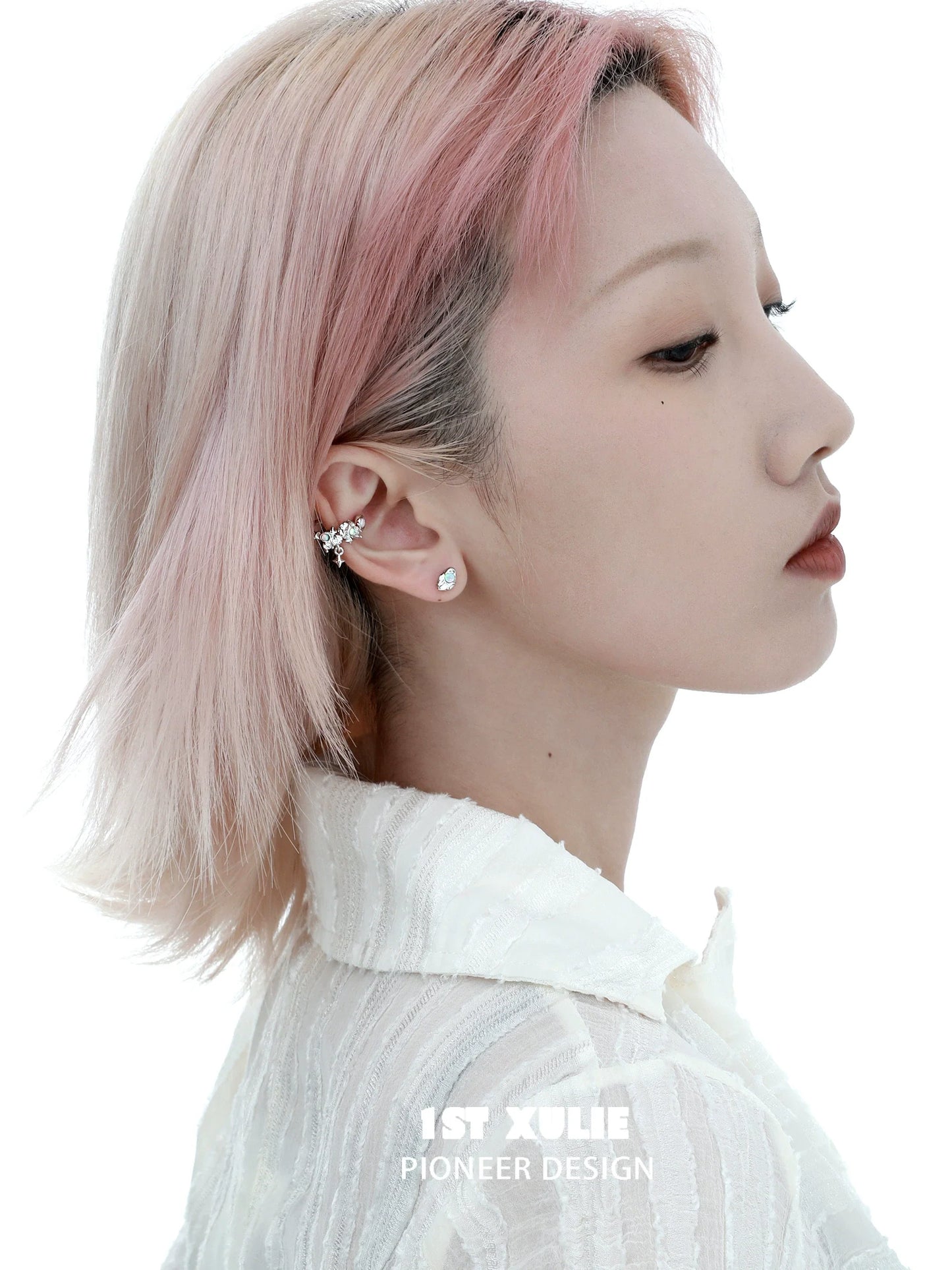 Fashionable Y2K thorned crown earrings showcased on a model with pink hair